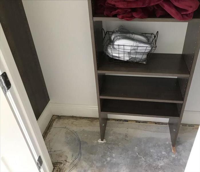 Closet with carpet removed after water migrated into it from the adjacent room.