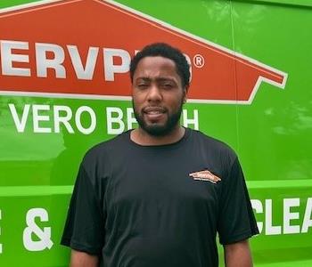 SERVPRO employee standing in front of truck