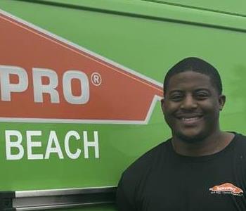 SERVPRO employee in black polo posing for crew photo.