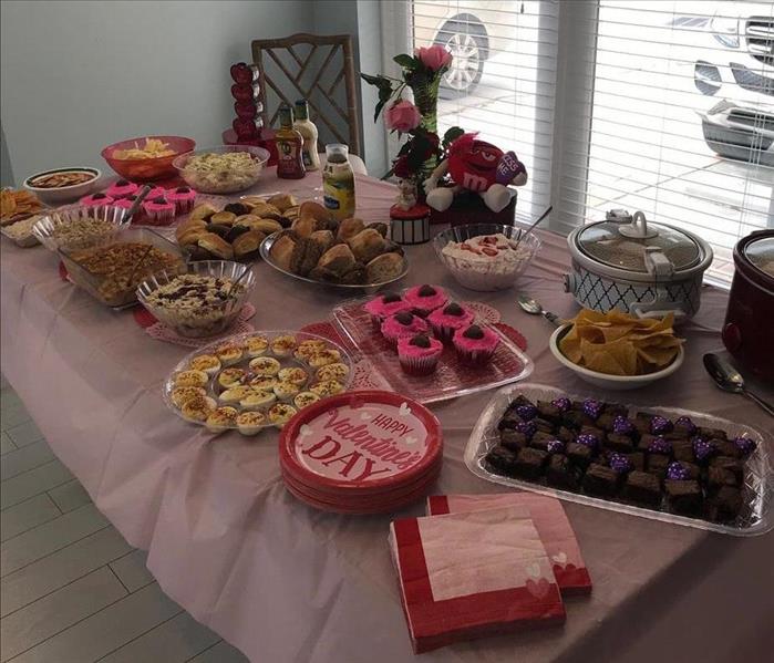 Table covered in Valentine's Day decor and sweet treats