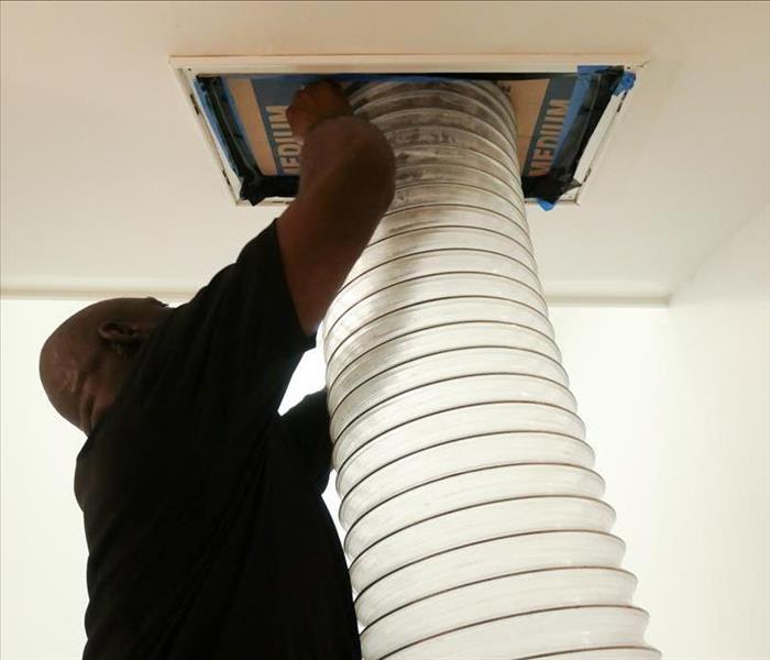 SERVPRO technician performing a duct cleaning