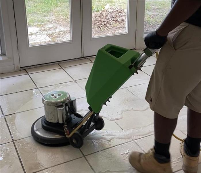 Technician Cleaning Tile