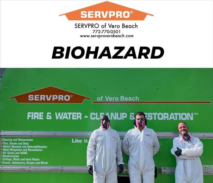 three men in full ppe standing in front of Servpro truck