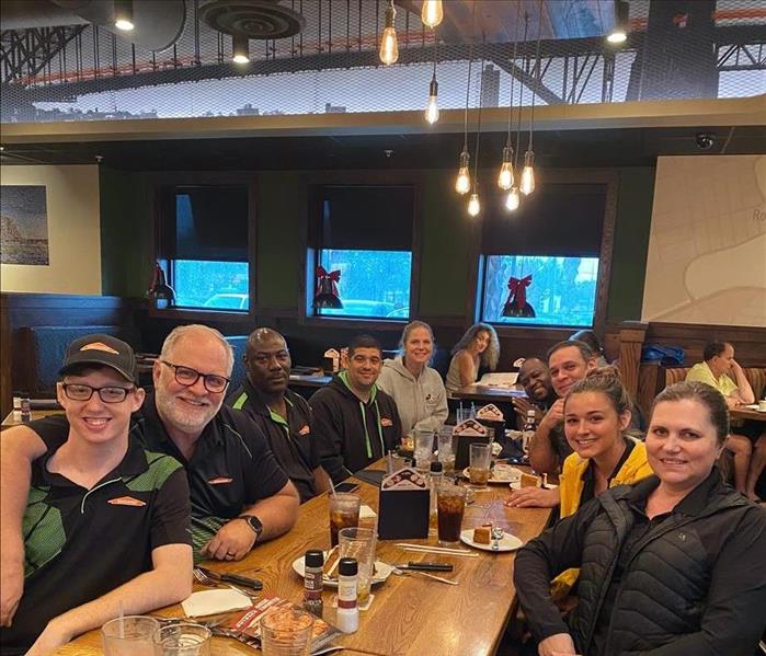 SERVPRO employees gathered around a table for lunch