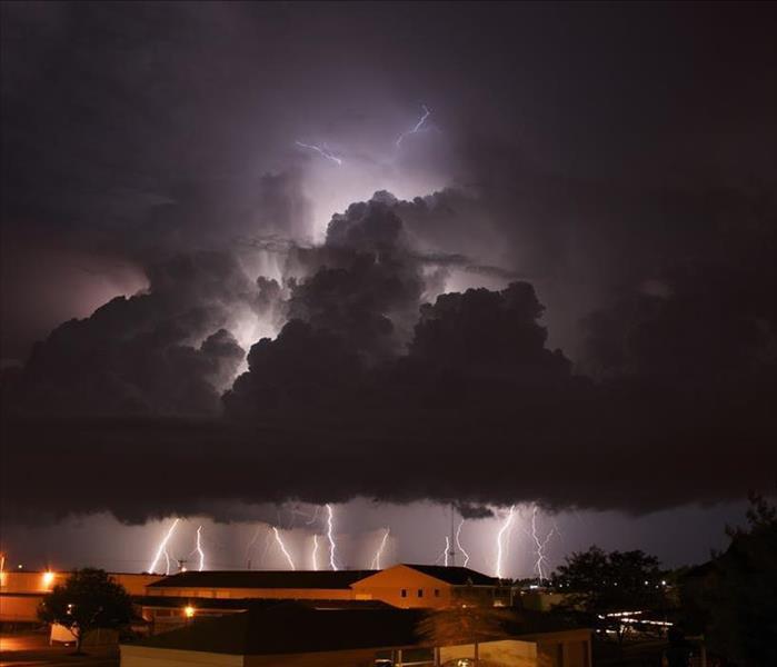 Night time image of a lightning storm above a residential area 