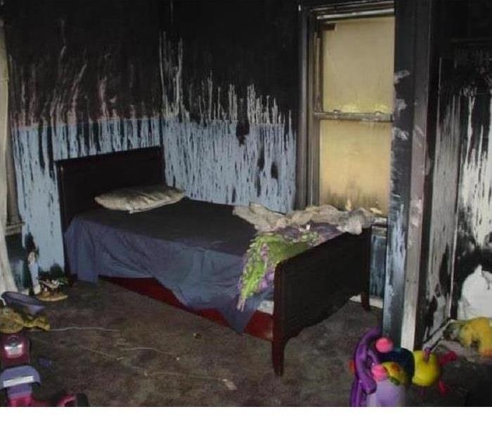 Bedroom with fire damage on structure and contents. 