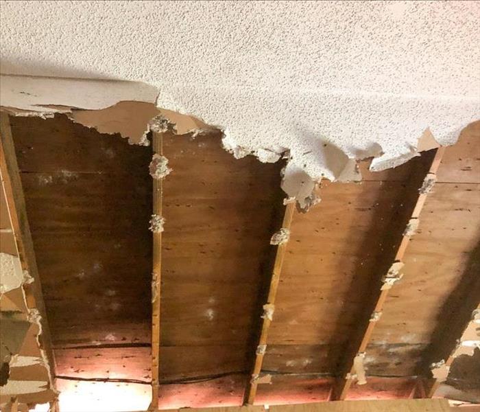 Ceiling and drywall torn out of a bedroom