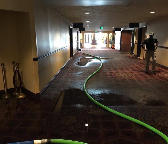 Hallway of commercial property flooded from pipe leak. 