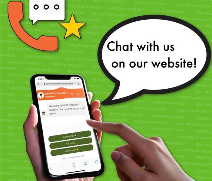 Graphic of hand holding smart phone with SERVPRO chat feature displayed on screen