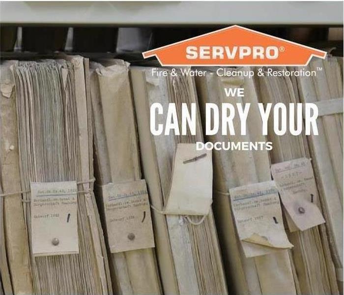 Background of bundled documents with the SERVPRO logo in top right corner and text that says “WE CAN DRY YOUR DOCUMENTS” 