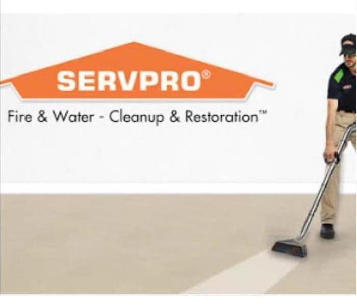 Man in SERVPRO uniform cleaning carpet. Servpro logo is in the top left hand corner.