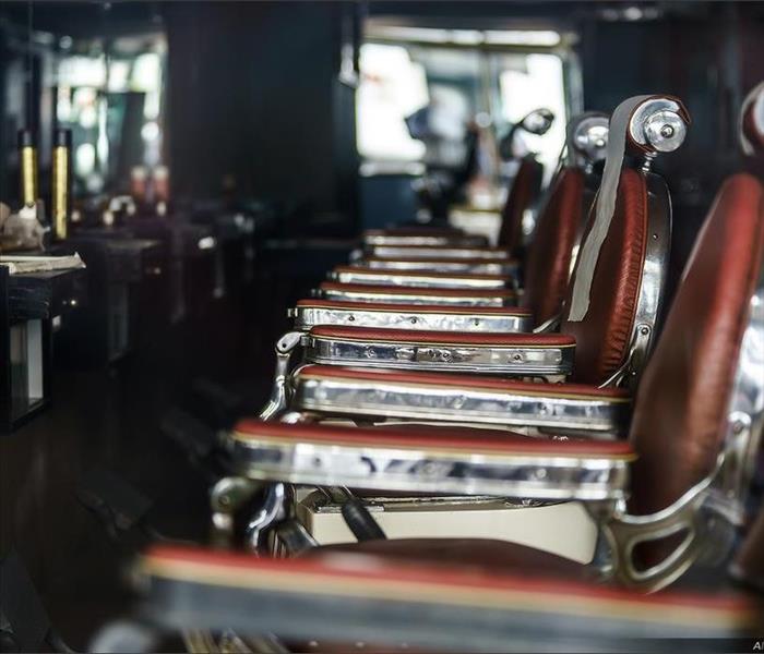 Three hair salon chairs and sinks in a salon 